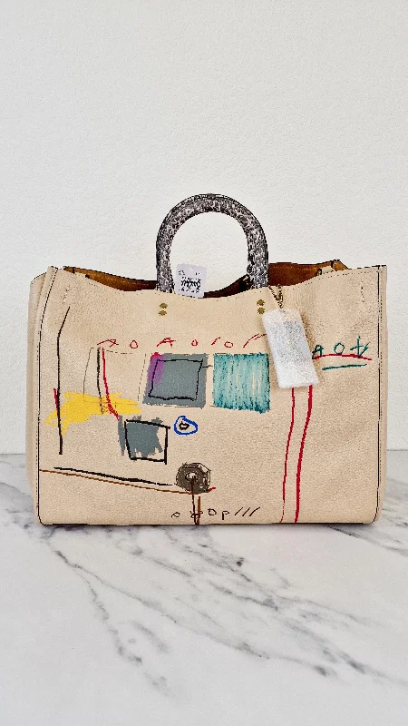 Small - sized Coach crossbody bags in smooth pebble leather for a compact carryCoach Rogue 39 Jean-Michel Basquiat Bag in Ivory Pebble Leather with Snakeskin - Handbag Shoulder Bag - Coach 6877